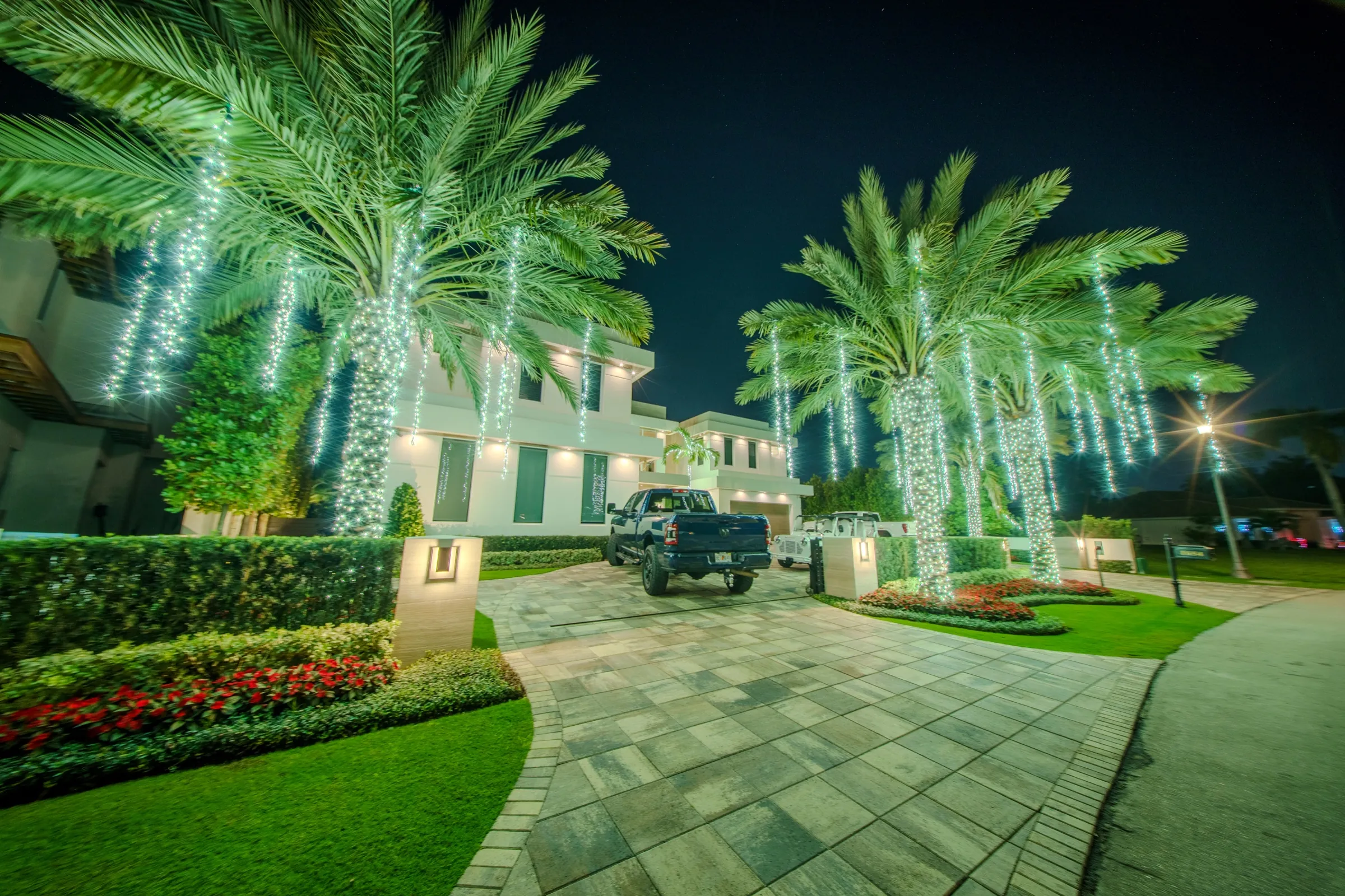 LED mini lights illuminating a residential estate at twilight — a true, pure white with no blue cast